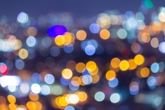 Unfocused shot with room for copyspace showing highrise buildings in a modern city with electricity lighting the highways and buildings, amid good night life and cityscape.