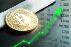 Bitcoin with rising arrow for increased values and profits for financial and business gain.  Physical golden bitcoin.  Learn how to invest on crypto exchange.