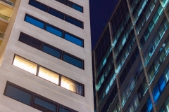 Apartment windows at night in big city highrises.