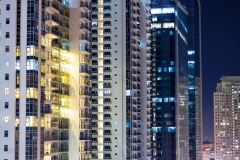 Apartment windows at night in big city highrises.