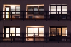 Apartment windows at night in the city.