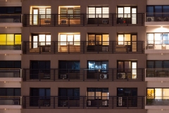 Apartment windows at night in the city.