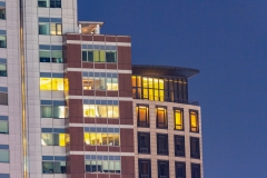 Apartment windows in the night time.  Big city living in highrise urban environment.  Real estate concept.