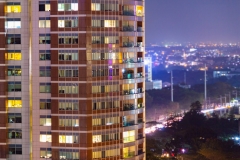 Apartment windows in the night time.  Big city living in highrise urban environment.  Real estate concept.