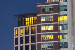 City apartment windows at night.  Residential highrise residences for metro housing in urban environment.