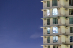 City apartment windows at night.  Residential highrise residences for metro housing in urban environment.