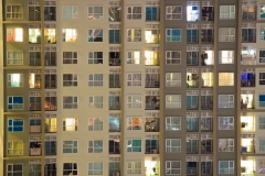 Glowing apartment windows at night where each occupant has his own privacy in the well planned high rise. Electrical power consumption has been designed to serve thousands.