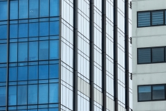 Modern steel and glass facade for office highrise buildings.  Construction underway for the new modern and contemporary skyscraper.