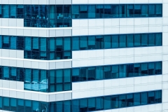 Office building facade with windows and modern steel construction.