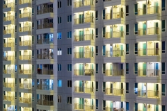 Tropical condo apartment windows at night.  Modern luxury highrise real estate and privacy for each unit.