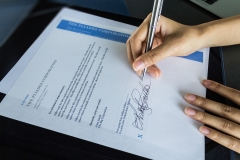Sign agreement for business contract.