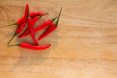 Room for copyspace in this chilli pepper shot on a wood grain cutting board with copyspace room.  Create a spicy new scrumptious and delectable meal idea that will amaze.