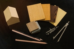 achitect samply materials for home design and construction concept with copy space.  pencils and protracters, house and wood grain samples with black background.