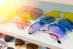 Sunglass shop selling different bright colored funky glasses for UV protection from the sun.  Eye glass online store.