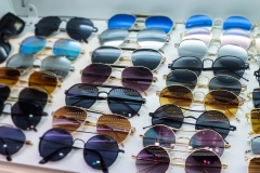 Sunglass shop with glasses and different apparel for peoples eyes to wear for UV protection from the sun.  Various and assorted shapes and sizes of glasses.